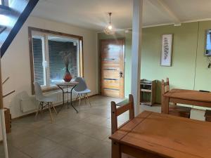 a living room with a table and chairs at Terra Hostal in Puerto Natales