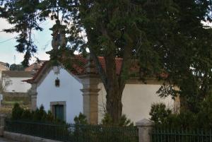 a white house with a tree in front of it at Hotel Rural Villa Julia in Vila Flor