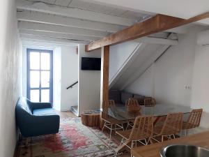 a living room with a table and chairs at HOTEL CASAS DA FORTALEZA Casa do Garda in Outeiro de Rei