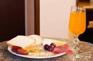 a plate of breakfast food and a glass of orange juice at Cairo Dream Boutique Hotel in Cairo