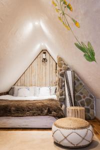 a bedroom with a large bed in a attic at Maciejewka in Zahoczewie