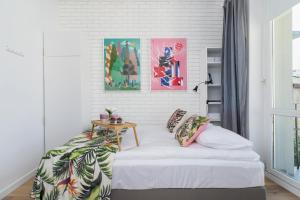 a bedroom with a bed with a table on it at Solna Studio Cracow by Renters in Krakow