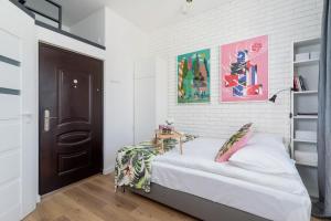 a bedroom with a bed and a black door at Solna Studio Cracow by Renters in Krakow