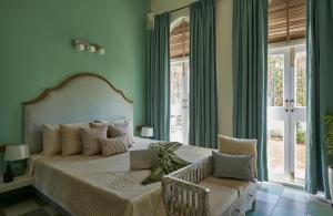 a bedroom with a bed with a laptop on it at LohonoStays Villa Aurelia E in Vagator