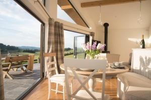 a dining room with a table and chairs and a window at Beautiful cottage in idyllic countryside setting in Montgomery