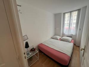 a small bedroom with a bed and a window at En Bord de Mer à Nice sur La Promenade des Anglais in Nice
