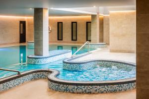 a hot tub in a hotel lobby with blue water at The Celtic Royal Hotel in Caernarfon