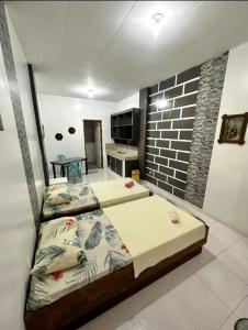 a bedroom with two beds and a brick wall at LindenApartment 