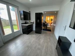 a large room with a kitchen and a living room at Maison T4 proche Bordeaux in Lormont