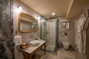 a bathroom with a sink and a shower at Luxury Cratus Stone Palace in Göreme