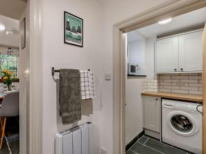a small kitchen with a washer and dryer in it at 2 Bed in Keswick 90064 in Threlkeld