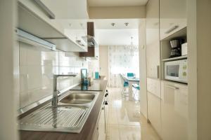 a kitchen with a sink and a microwave at Apartment Carmela in Split