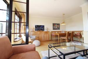 a living room with a table and a dining room at Dünental 6b in Wenningstedt