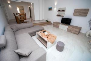 a living room with a couch and a tv at Villa Manuela near Medulin with private pool only 500 meters from sea in Banjole