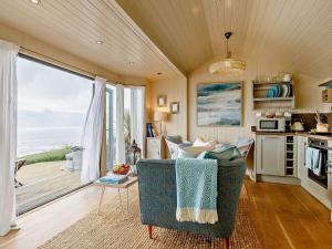 a living room with a view of the ocean at 1 Bed in Whitsand Bay 90168 in Antony