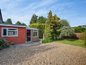 a red house with a gravel driveway at 3 Bed in Briston 90184 in Briston