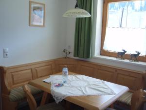 a dining room table with a bottle of water on it at Leirerfeld in Alpbach