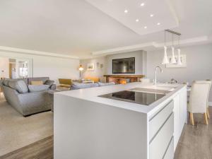 a kitchen and living room with a white counter top at 5 Bed in Edinburgh 90141 