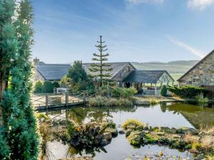 a garden with a pond in front of a house at 5 Bed in Edinburgh 90141 