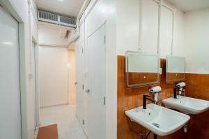 a bathroom with two sinks and two mirrors at Yimwhan House 02, Ayutthaya old town in Phra Nakhon Si Ayutthaya