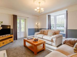 a living room with a couch and a table at 5 Bed in Wisbech 90134 in Wisbech