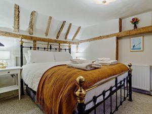 a bedroom with a large bed with a wooden frame at 2 bed property in Bury St Edmunds 90090 in Rattlesden