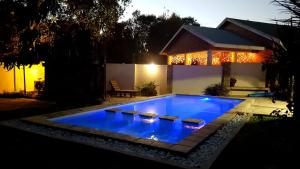 a swimming pool in a backyard at night at 39 HOOG STREET in Polokwane