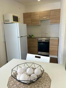 a kitchen with a white refrigerator and a bowl of mushrooms at T8 BUDGET 2 Bedroom+Living room Apartment @ agglomeration Taplanszentkereszt in Szombathely