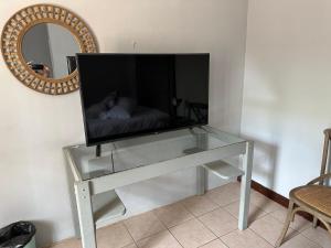a television on a glass table in a living room at 39 HOOG STREET in Polokwane