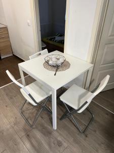 a white table with two chairs and a plate on it at T8 BUDGET 2 Bedroom+Living room Apartment @ agglomeration Taplanszentkereszt in Szombathely