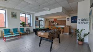 a room with a pool table in the middle of it at Auberge de Jeunesse HI Cherbourg in Cherbourg en Cotentin