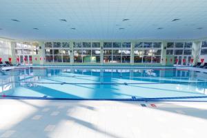 a large swimming pool in a large building at Apartmán Senica in Senica