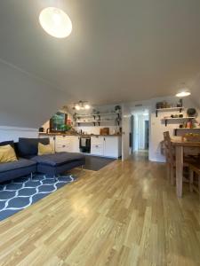 a living room with a blue couch and a table at The Triangle Lodge in Invergarry