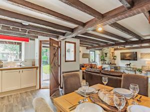 a dining room and living room with a table and chairs at 3 Bed in Lanhydrock 90217 in Bodmin