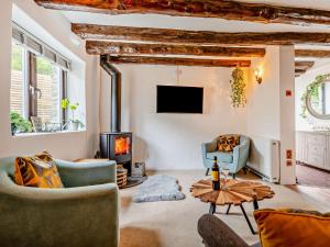 a living room with two chairs and a fireplace at 2 Bed in Lanhydrock 90216 in Bodmin