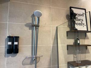 a shower with a shower head in a bathroom at Ashri HH Bright Apt-Damac hills2 in Dubai