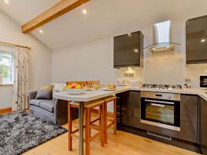 a kitchen with a table and a couch in a room at 1 Bed in Sowerby Bridge 90213 in Sowerby Bridge