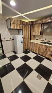 a kitchen with a black and white checkered floor at منتزة درة العروس in Taif
