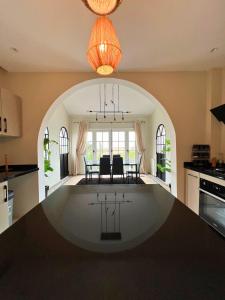 a kitchen with an archway in the middle of a table at La Finca - 3BR Seaside Villa with Private Pool & BBQ in Tangier