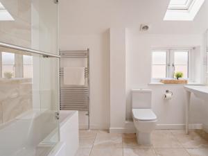 a white bathroom with a toilet and a shower at 3 Bed in Newport 90246 in Newport