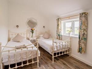 a bedroom with two beds and a window at 3 Bed in Newport 90246 in Newport