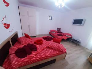 a bedroom with four red beds with red pillows at Cazare Centru Brasov in Braşov