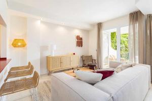 a living room with a white couch and a window at Sunny Home in Benalmádena