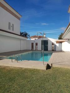 a swimming pool in front of a house at Sunny Home in Benalmádena