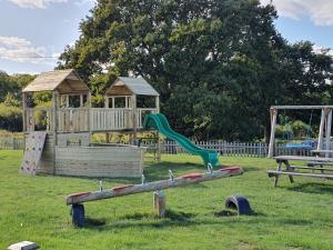 a wooden playground with a slide and a gazebo at 2 Bed in Newport 90247 in Newport