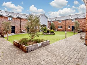 a building with a courtyard with a tree in it at 2 Bed in Newport 90243 in Newport