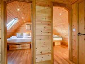 a bedroom in a log cabin with a bed at 2 Bed in Rhayader 90280 in Saint Harmon