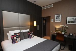 a hotel room with a bed and a desk and a desk at Hôtel Château de Lacan in Brive-la-Gaillarde