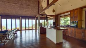 a large kitchen with a counter and some windows at Why Nam Beach in Haad Yuan