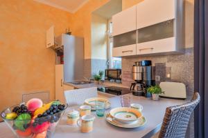 a kitchen with a table with a bowl of fruit on it at Der Schlosshof - 02 in Pudagla